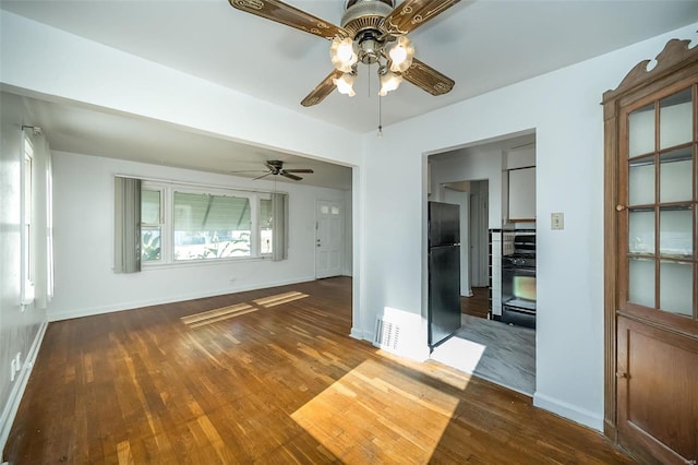 spare room with ceiling fan and dark hardwood / wood-style flooring