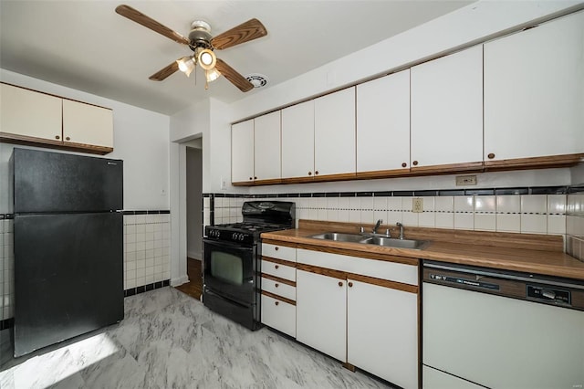 kitchen with sink, black appliances, ceiling fan, white cabinets, and tasteful backsplash