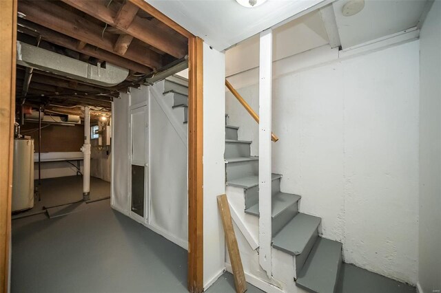 basement with stairs and gas water heater