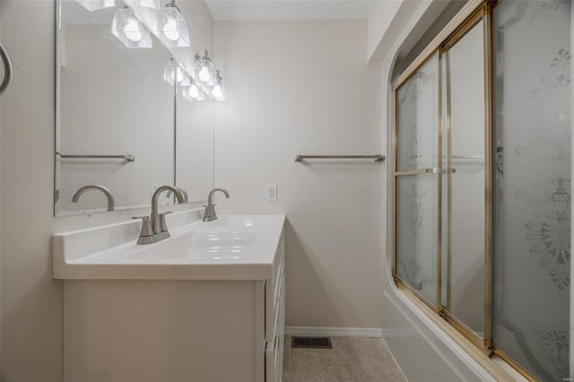 bathroom with vanity, tile patterned floors, and shower / bath combination with glass door