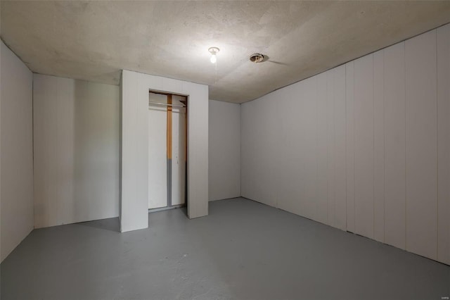 basement featuring a textured ceiling