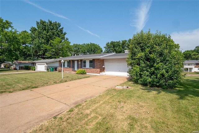 ranch-style house with a garage and a front lawn