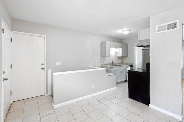 kitchen with black dishwasher, light tile patterned flooring, extractor fan, and sink