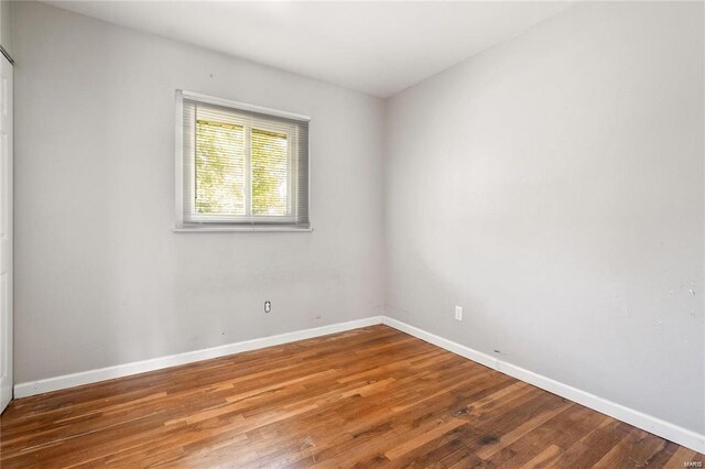 unfurnished room with wood-type flooring