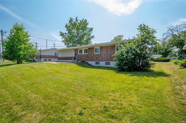 rear view of property featuring a yard