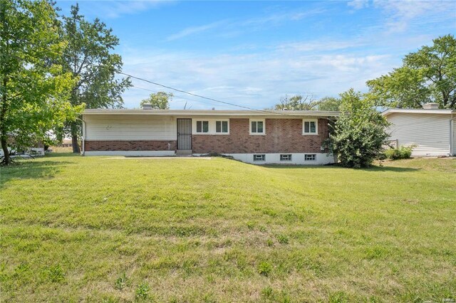 rear view of house with a yard