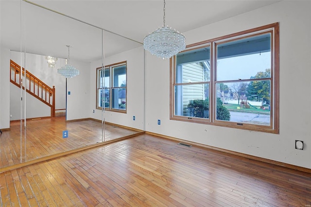 interior space featuring wood-type flooring and a chandelier