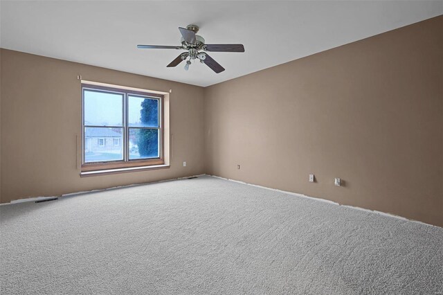 empty room featuring carpet flooring and ceiling fan