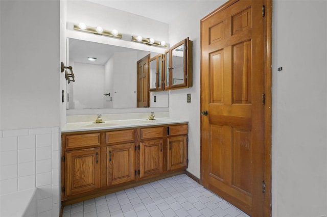 bathroom with vanity, tile patterned floors, and a bath