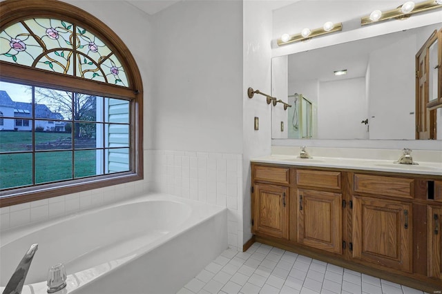 bathroom featuring a bath, tile patterned flooring, and vanity