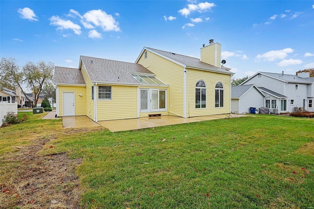 rear view of house with a yard and a patio area