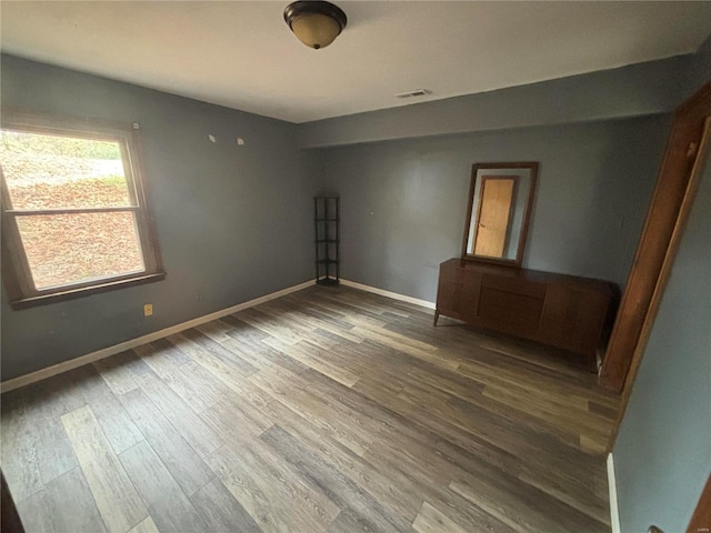 spare room with hardwood / wood-style flooring