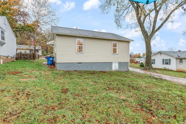 view of side of property with a lawn