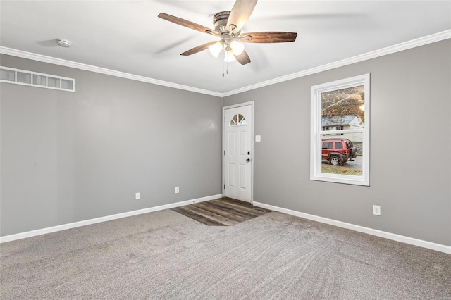 carpeted empty room featuring ceiling fan and crown molding