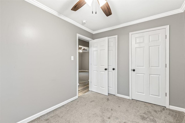 unfurnished bedroom with light colored carpet, ceiling fan, and crown molding