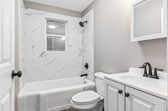 full bathroom with toilet, tiled shower / bath combo, and vanity