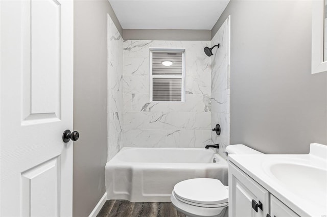 full bathroom featuring hardwood / wood-style flooring, vanity, toilet, and tiled shower / bath combo