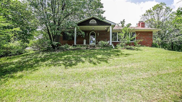 view of front facade with a front lawn and covered porch