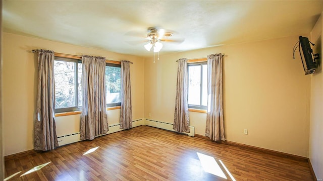 unfurnished room with ceiling fan and hardwood / wood-style flooring