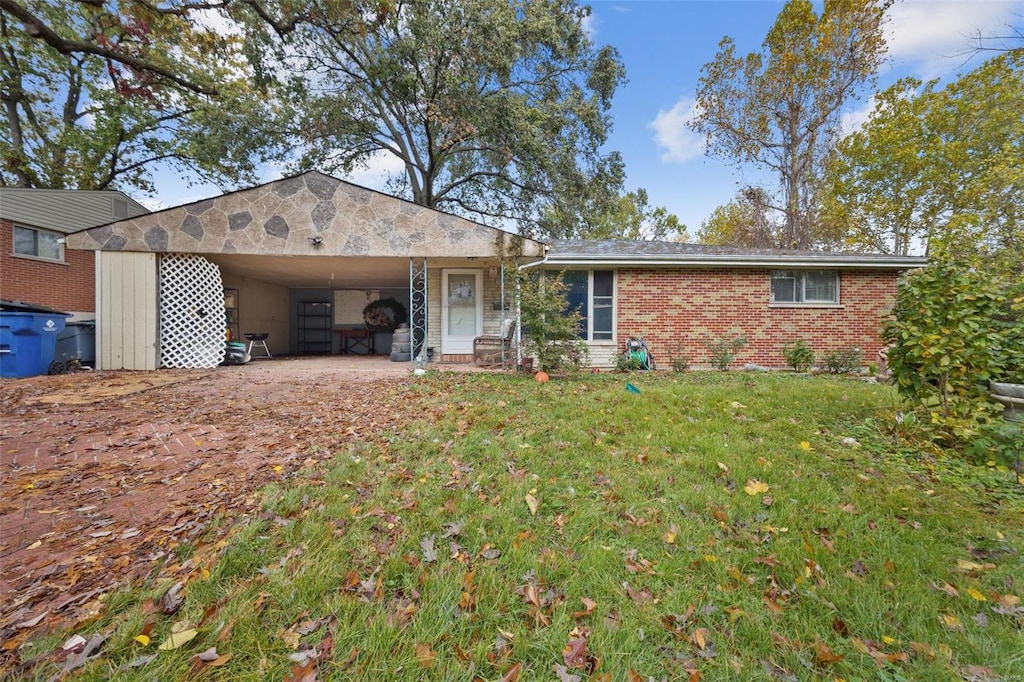 ranch-style house with a front lawn and a carport