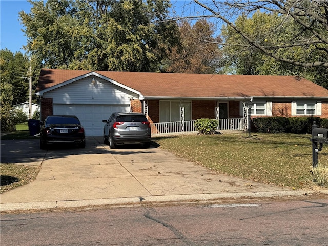 single story home featuring covered porch, a garage, and a front yard