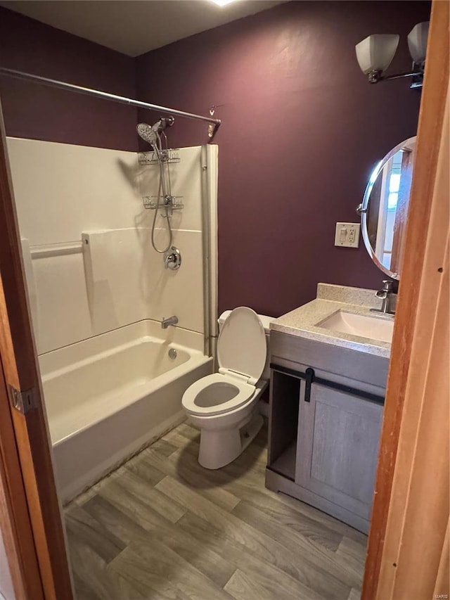 full bathroom featuring vanity, toilet, hardwood / wood-style flooring, and shower / tub combination