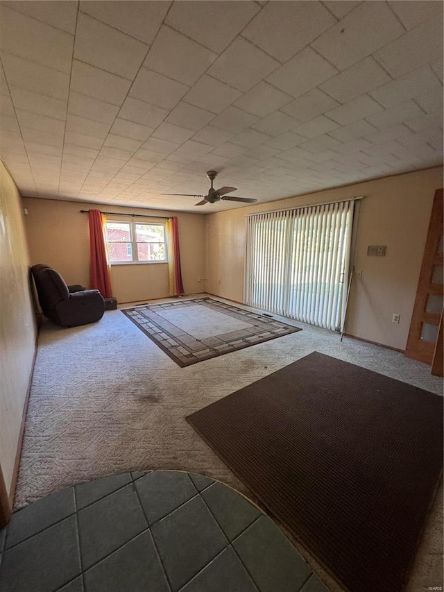 spare room featuring ceiling fan and carpet