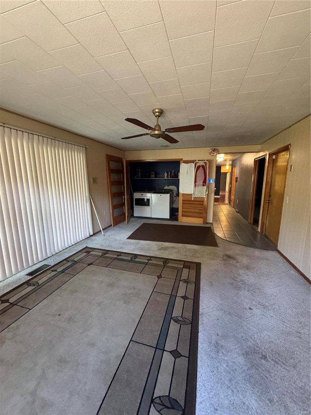 unfurnished living room featuring carpet flooring and ceiling fan