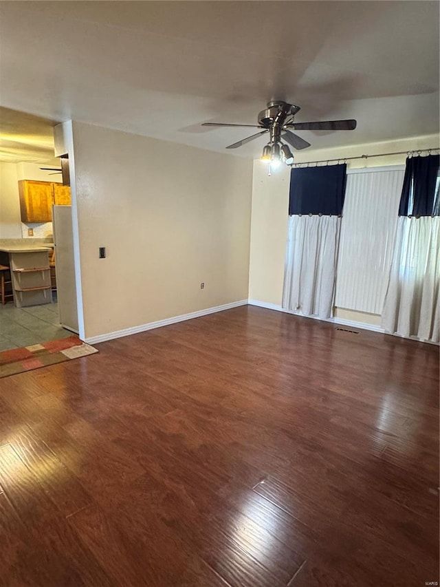 spare room featuring ceiling fan and hardwood / wood-style floors