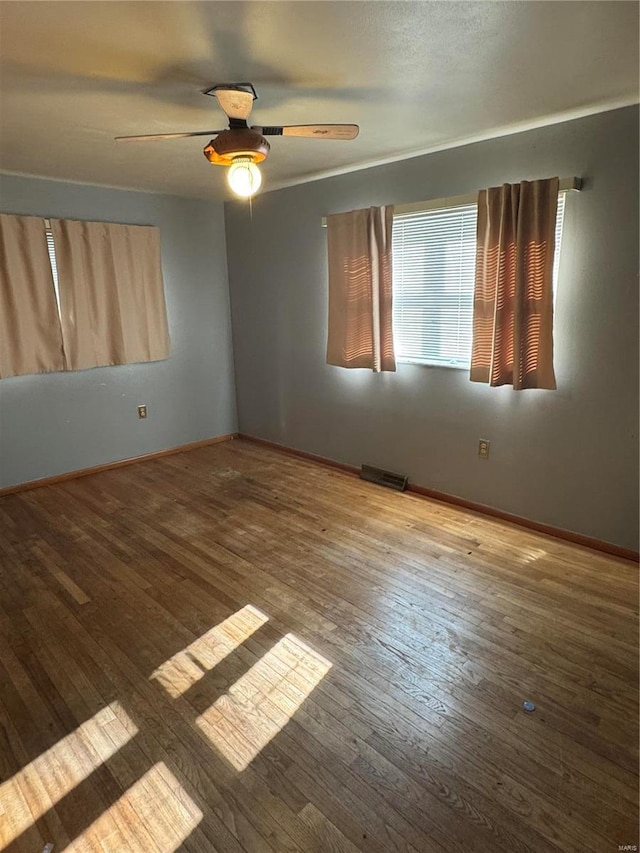 unfurnished room featuring hardwood / wood-style floors and ceiling fan