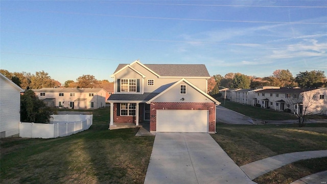 view of front of home with a front yard and a garage