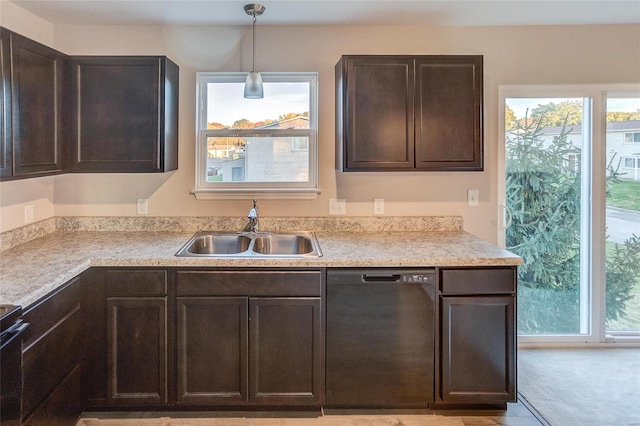 kitchen featuring dark brown cabinets, light colored carpet, sink, dishwasher, and hanging light fixtures