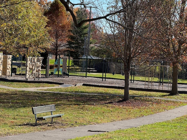 view of home's community featuring a playground and a lawn