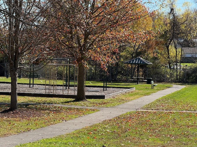 surrounding community featuring a playground and a yard