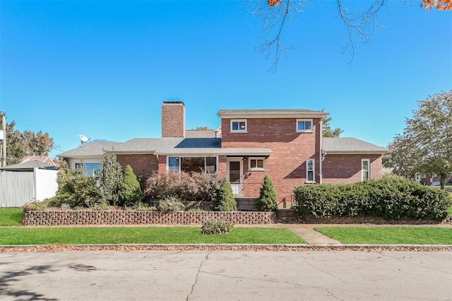 rear view of property with a yard