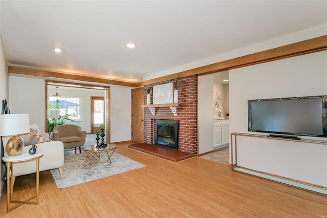 living room featuring light hardwood / wood-style flooring and a fireplace