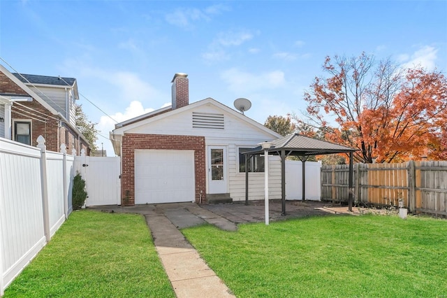 back of property with a gazebo and a lawn