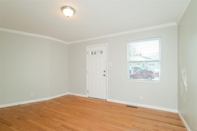 foyer featuring light hardwood / wood-style floors and crown molding