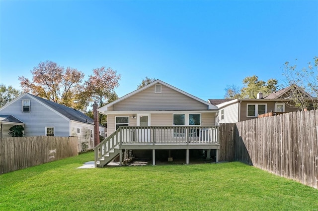 back of house featuring a lawn and a wooden deck