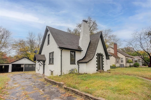 view of side of home featuring central AC unit and a lawn