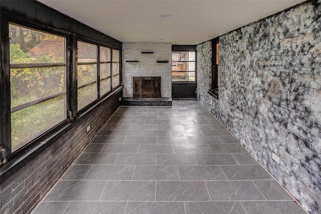 unfurnished sunroom featuring a fireplace