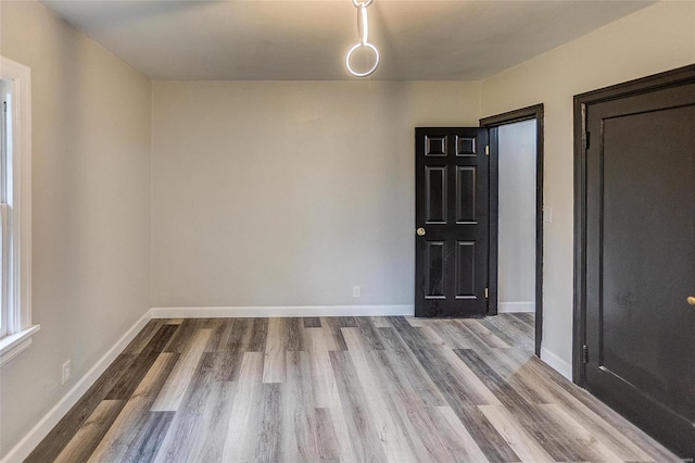 empty room with light hardwood / wood-style flooring