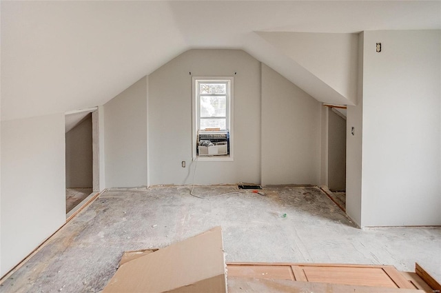 additional living space featuring cooling unit and vaulted ceiling