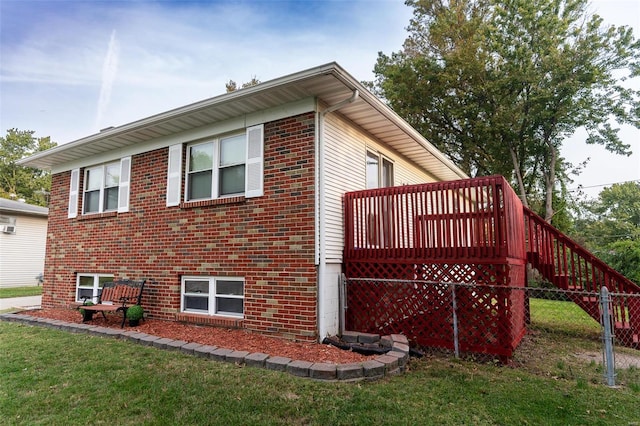 view of side of home with a lawn and a deck