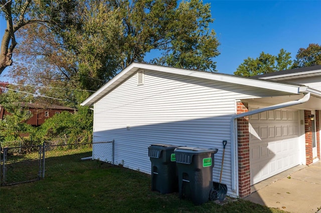 view of home's exterior featuring a lawn and a garage