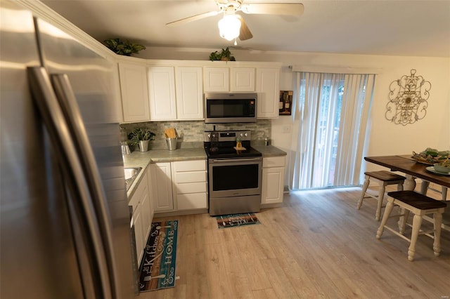 kitchen featuring light hardwood / wood-style floors, white cabinetry, and stainless steel appliances