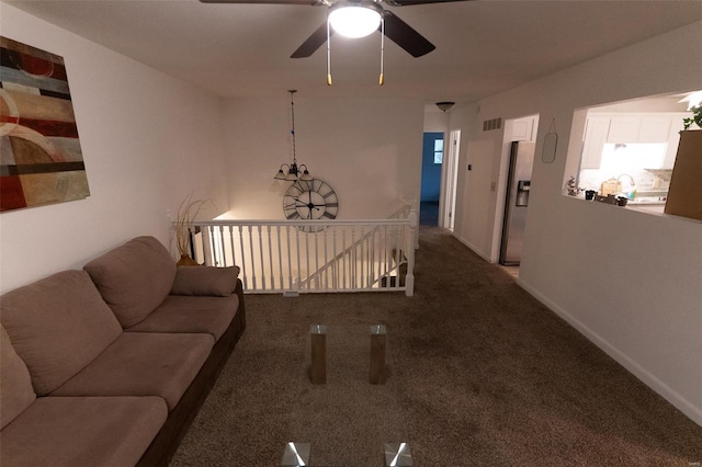 carpeted living room with ceiling fan