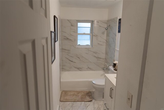 full bathroom with toilet, vanity, and tiled shower / bath