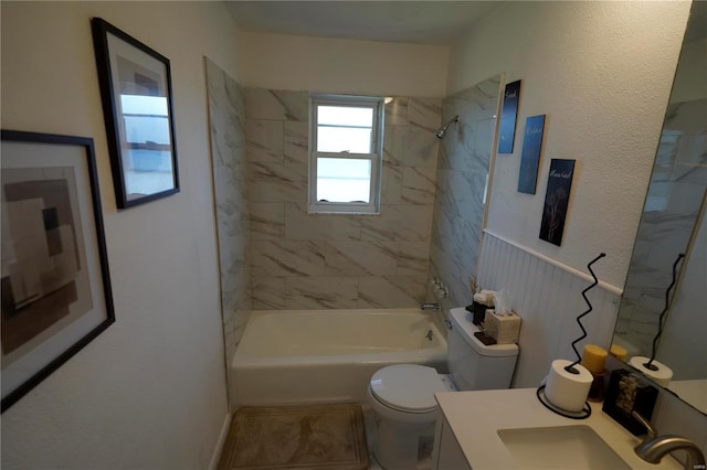 full bathroom featuring toilet, vanity, and tiled shower / bath