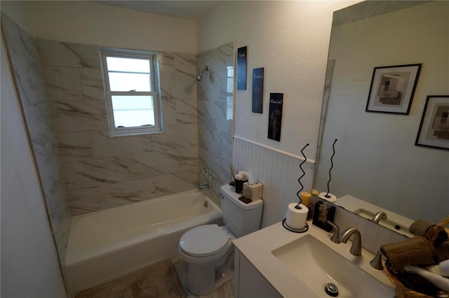 full bathroom with tiled shower / bath combo, toilet, and vanity